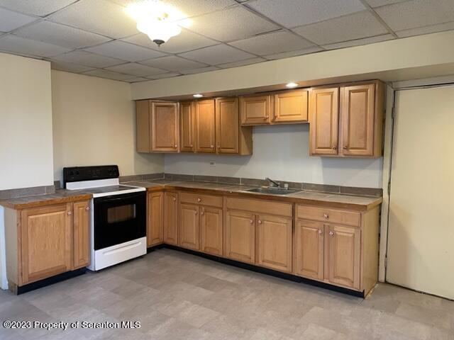 a kitchen with granite countertop white cabinets and stainless steel appliances