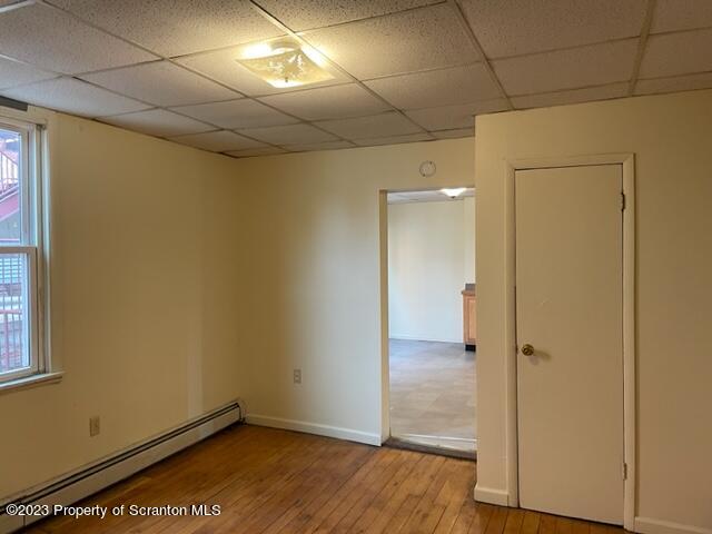 317 Cedar Avenue Scranton, PA 18505 - Photo 3 of 7 an empty room with wooden floor and windows