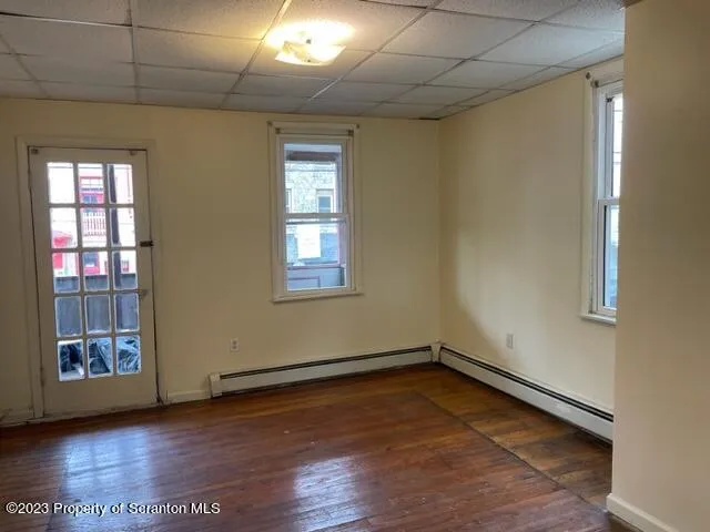 a view of a room with wooden floor and natural light