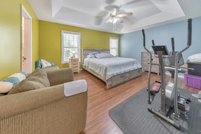 a bedroom with furniture and a wooden floor
