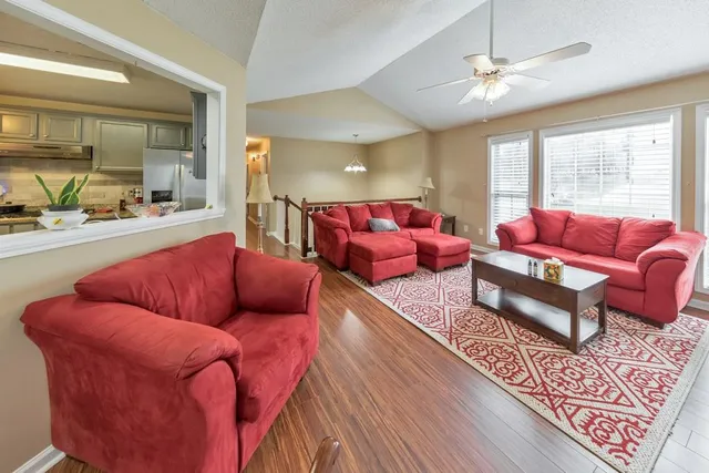 a living room with furniture a rug and a chandelier