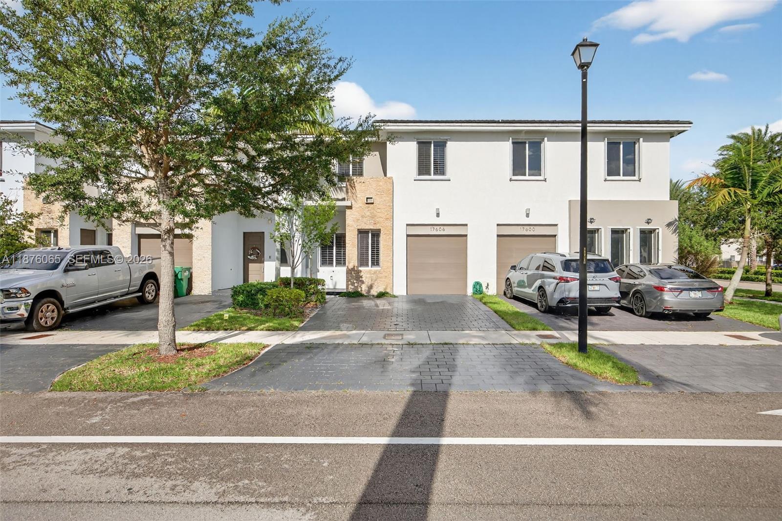 17606 Southwest 149th Place, Unit 17606 Miami, FL 33187 - Photo 1 of 69 a view of a street with cars on road