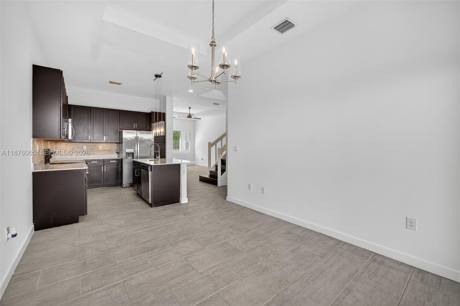 17606 Southwest 149th Place, Unit 17606 Miami, FL 33187 - Photo 16 of 69 a kitchen with stainless steel appliances a refrigerator sink and microwave