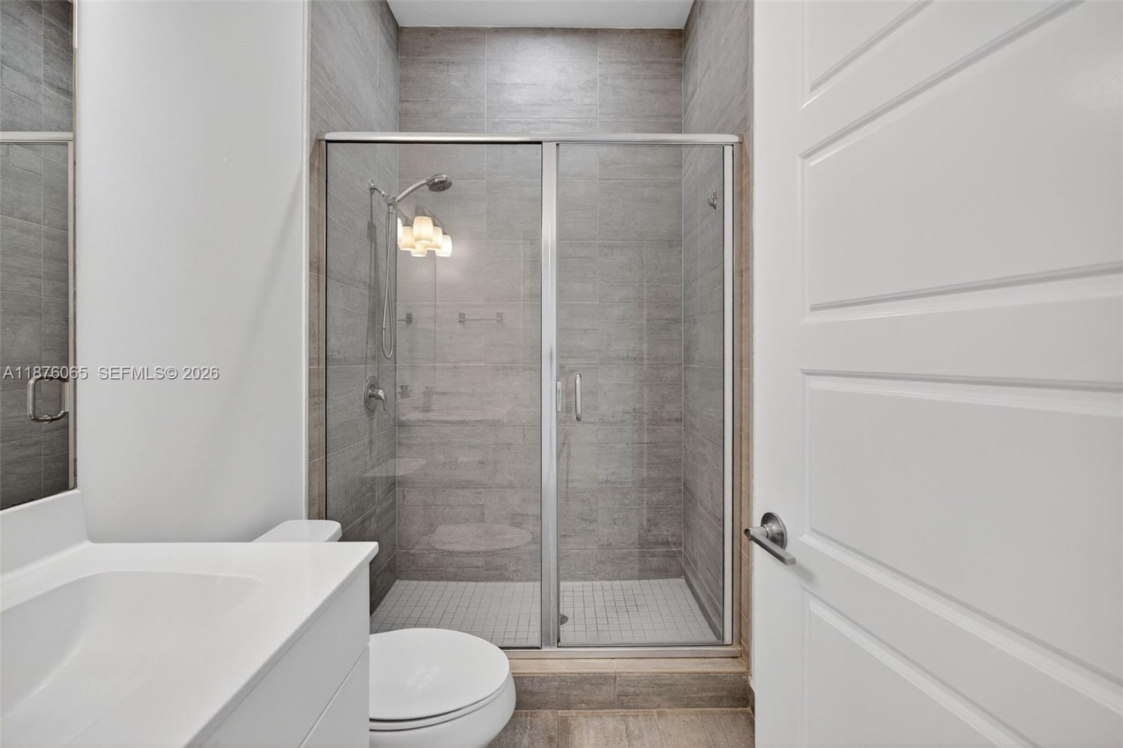 17606 Southwest 149th Place, Unit 17606 Miami, FL 33187 - Photo 18 of 69 a bathroom with a shower and a toilet