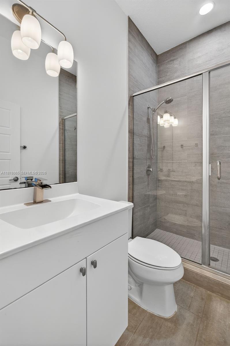 17606 Southwest 149th Place, Unit 17606 Miami, FL 33187 - Photo 20 of 69 a bathroom with a sink a toilet and shower