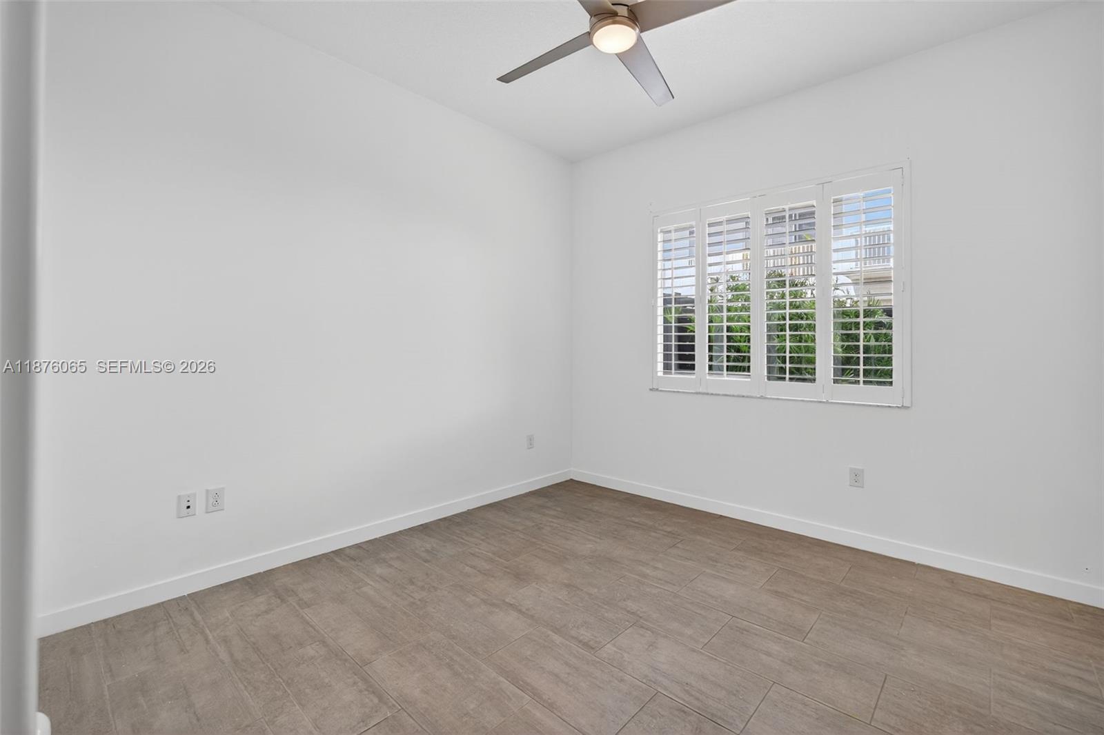 17606 Southwest 149th Place, Unit 17606 Miami, FL 33187 - Photo 21 of 69 an empty room with a window