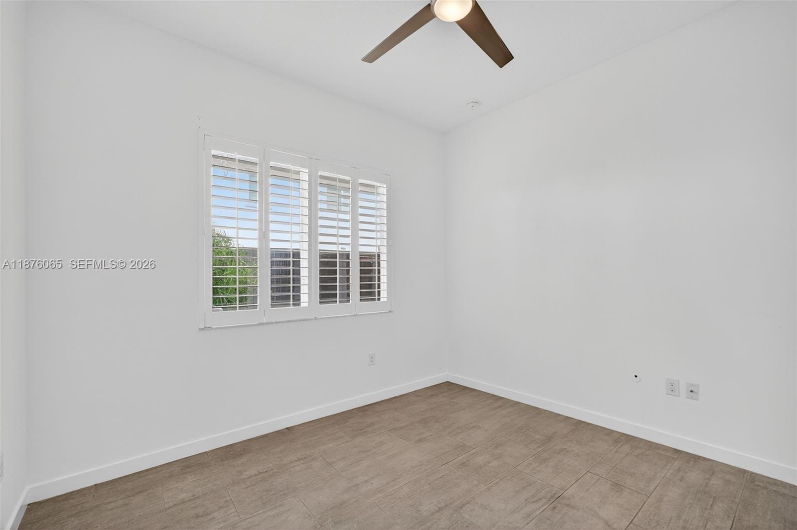 17606 Southwest 149th Place, Unit 17606 Miami, FL 33187 - Photo 23 of 69 an empty room with a window