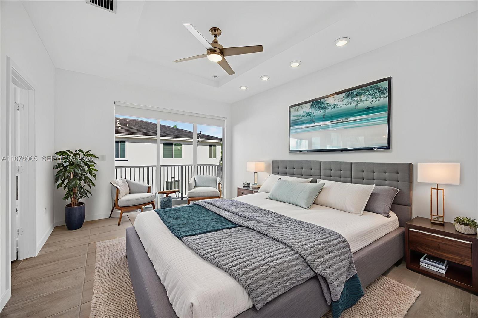 17606 Southwest 149th Place, Unit 17606 Miami, FL 33187 - Photo 26 of 69 a spacious bedroom with a balcony a bed and a large window