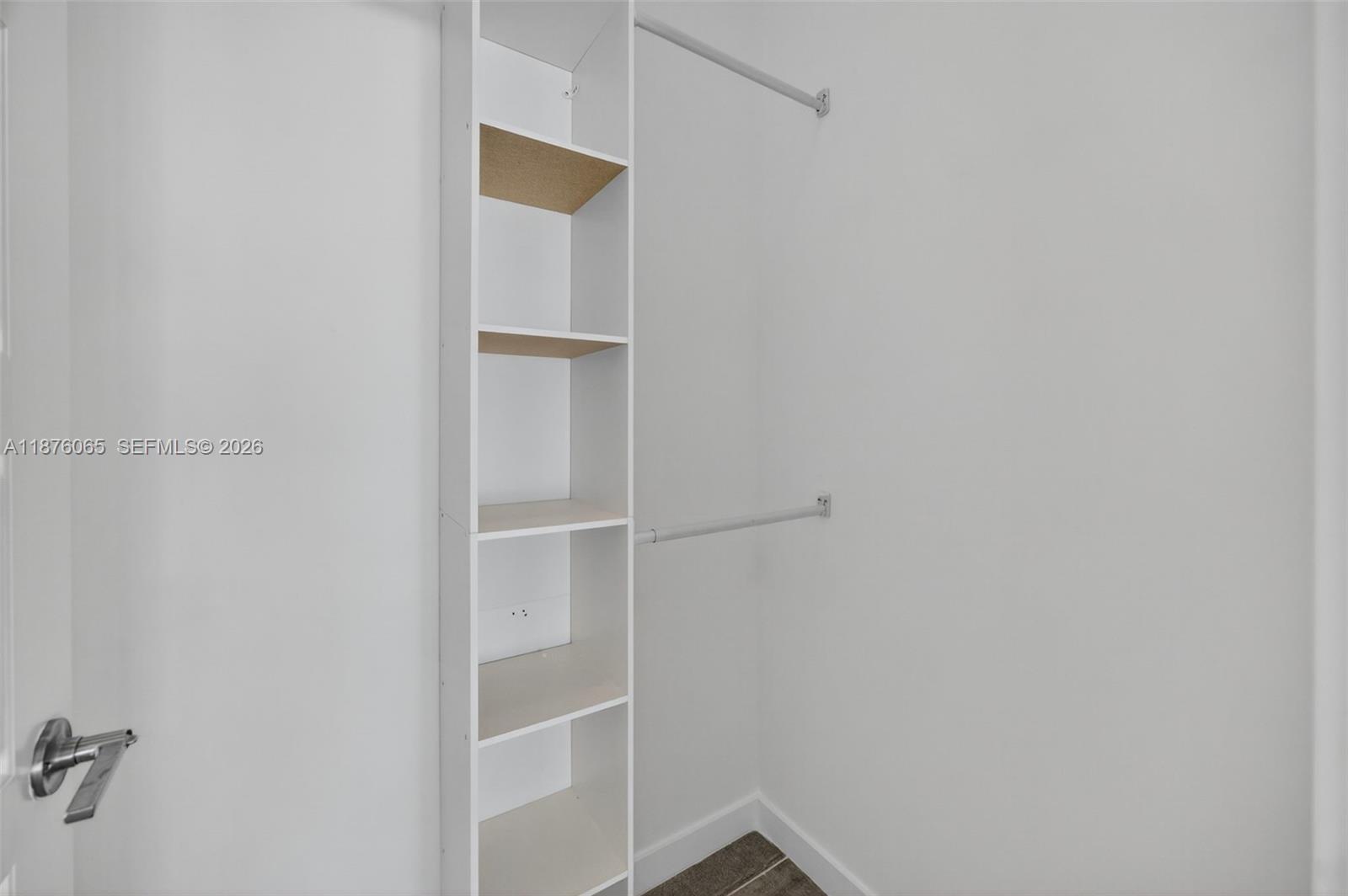 17606 Southwest 149th Place, Unit 17606 Miami, FL 33187 - Photo 27 of 69 a view of an empty walk in closet