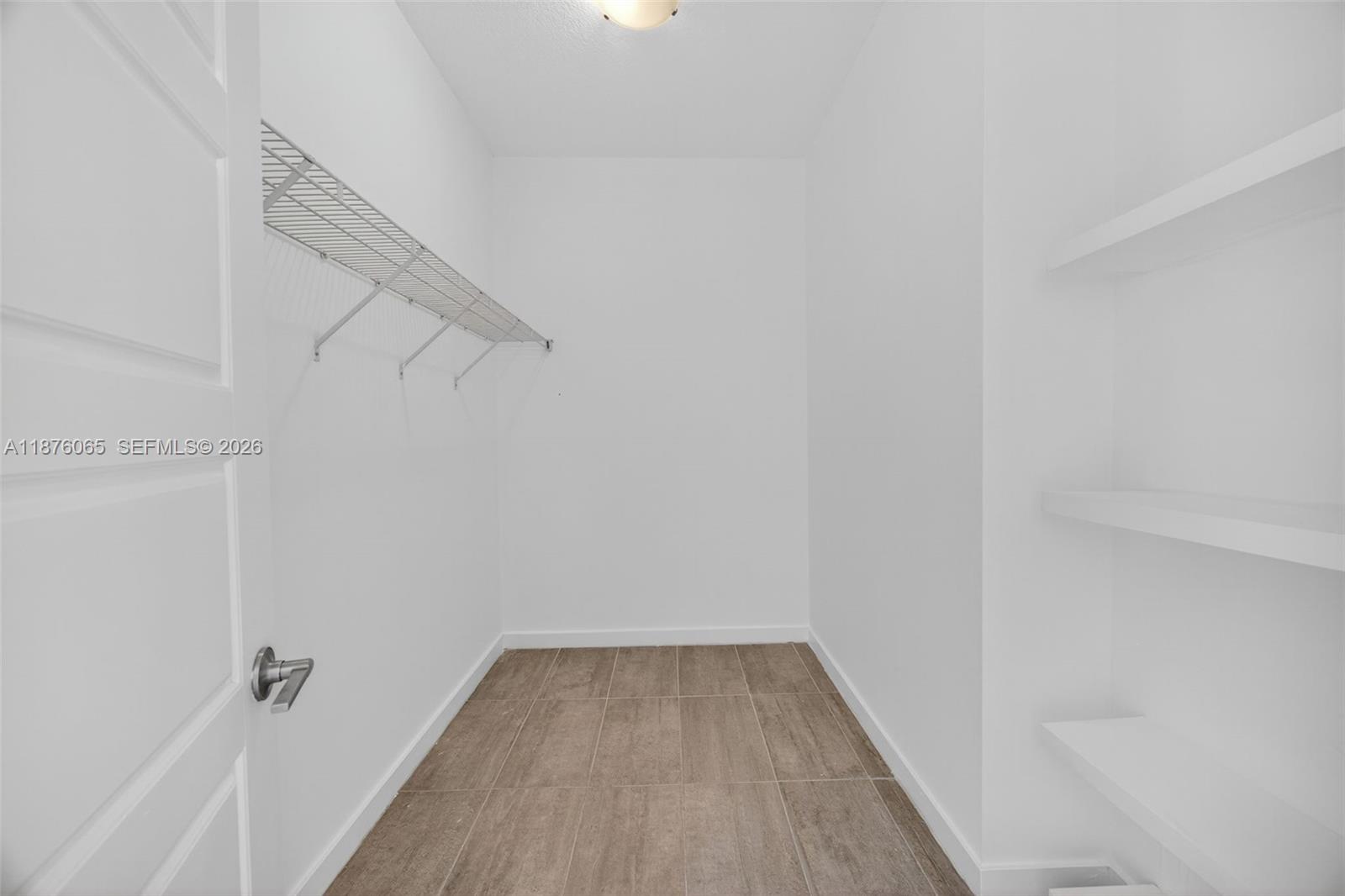 17606 Southwest 149th Place, Unit 17606 Miami, FL 33187 - Photo 29 of 69 a view of a room with racks on the wall