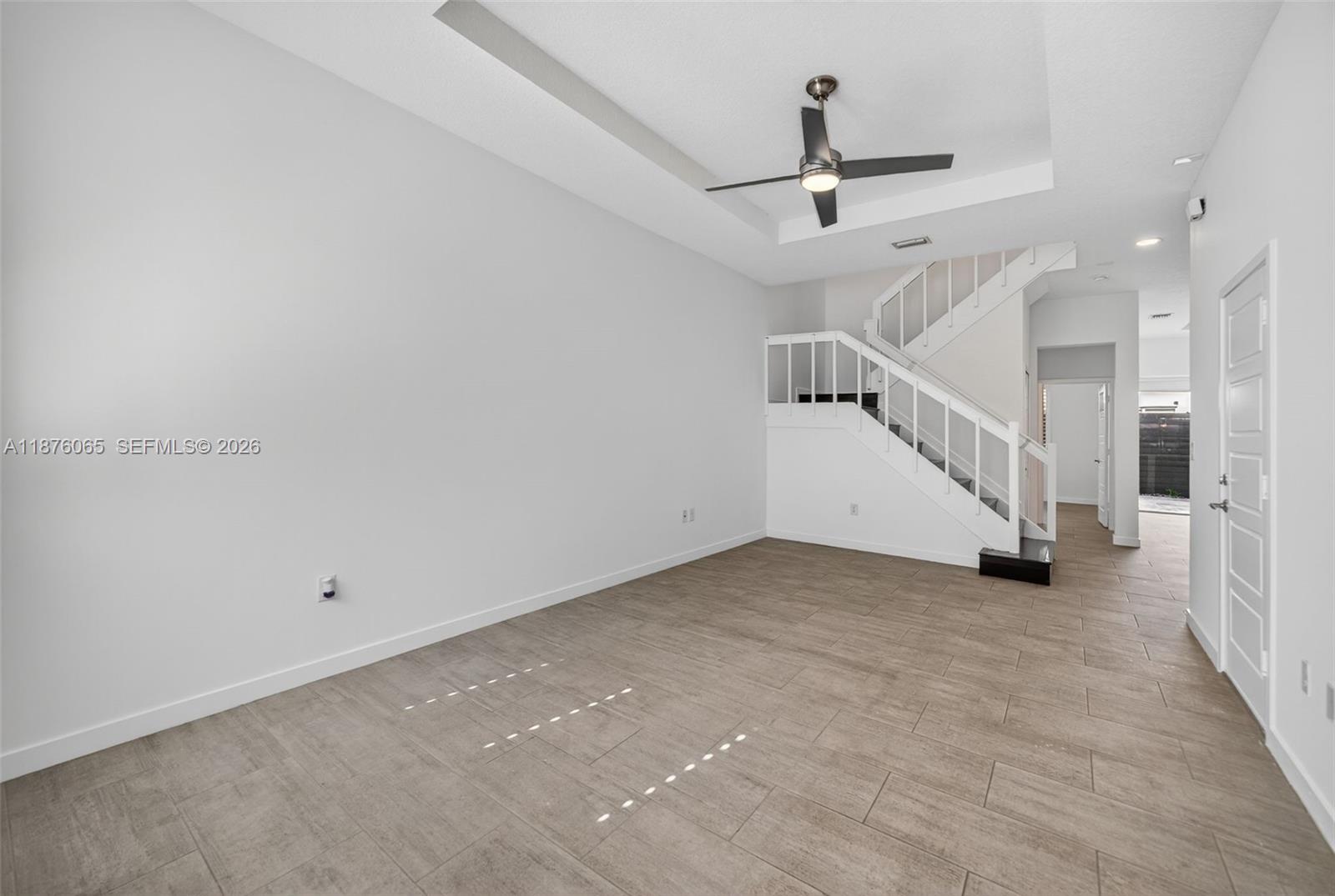 17606 Southwest 149th Place, Unit 17606 Miami, FL 33187 - Photo 3 of 69 a view of a room with stairs and a ceiling fan