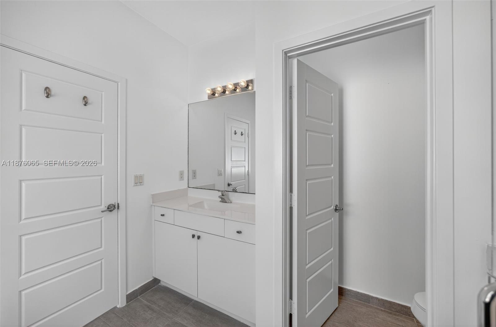 17606 Southwest 149th Place, Unit 17606 Miami, FL 33187 - Photo 32 of 69 a bathroom with a shower sink and mirror