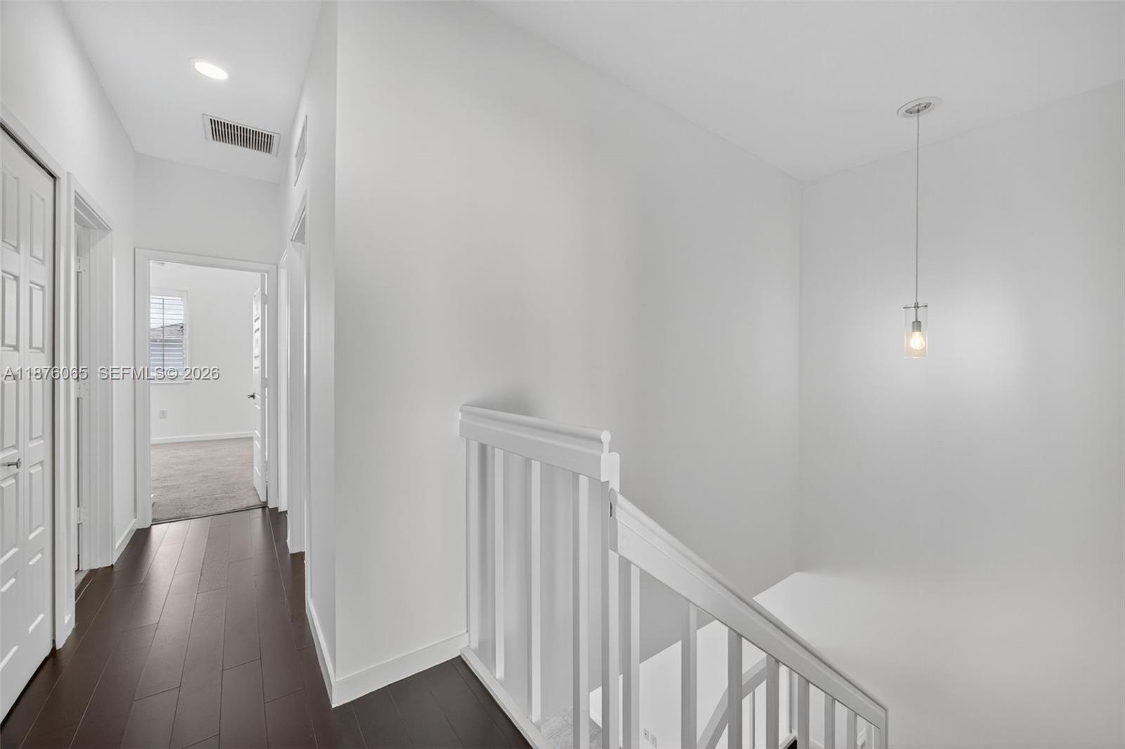 17606 Southwest 149th Place, Unit 17606 Miami, FL 33187 - Photo 37 of 69 a view of a hallway with wooden floor