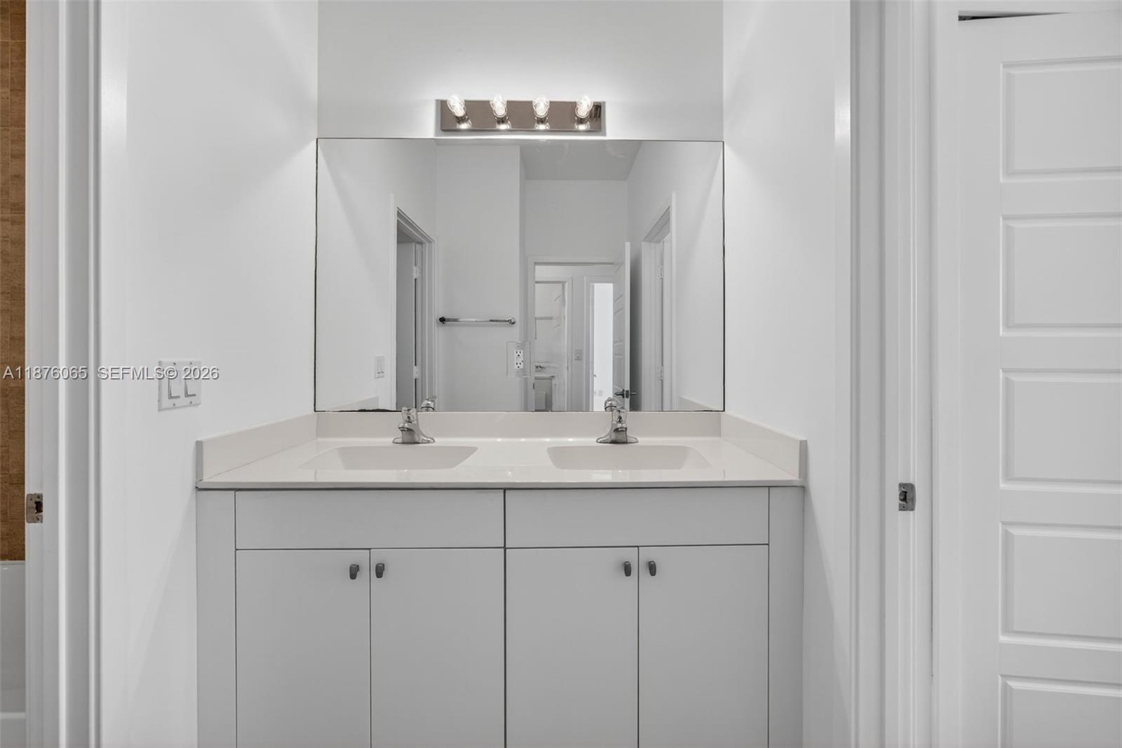 17606 Southwest 149th Place, Unit 17606 Miami, FL 33187 - Photo 39 of 69 a bathroom with a granite countertop sink and a mirror
