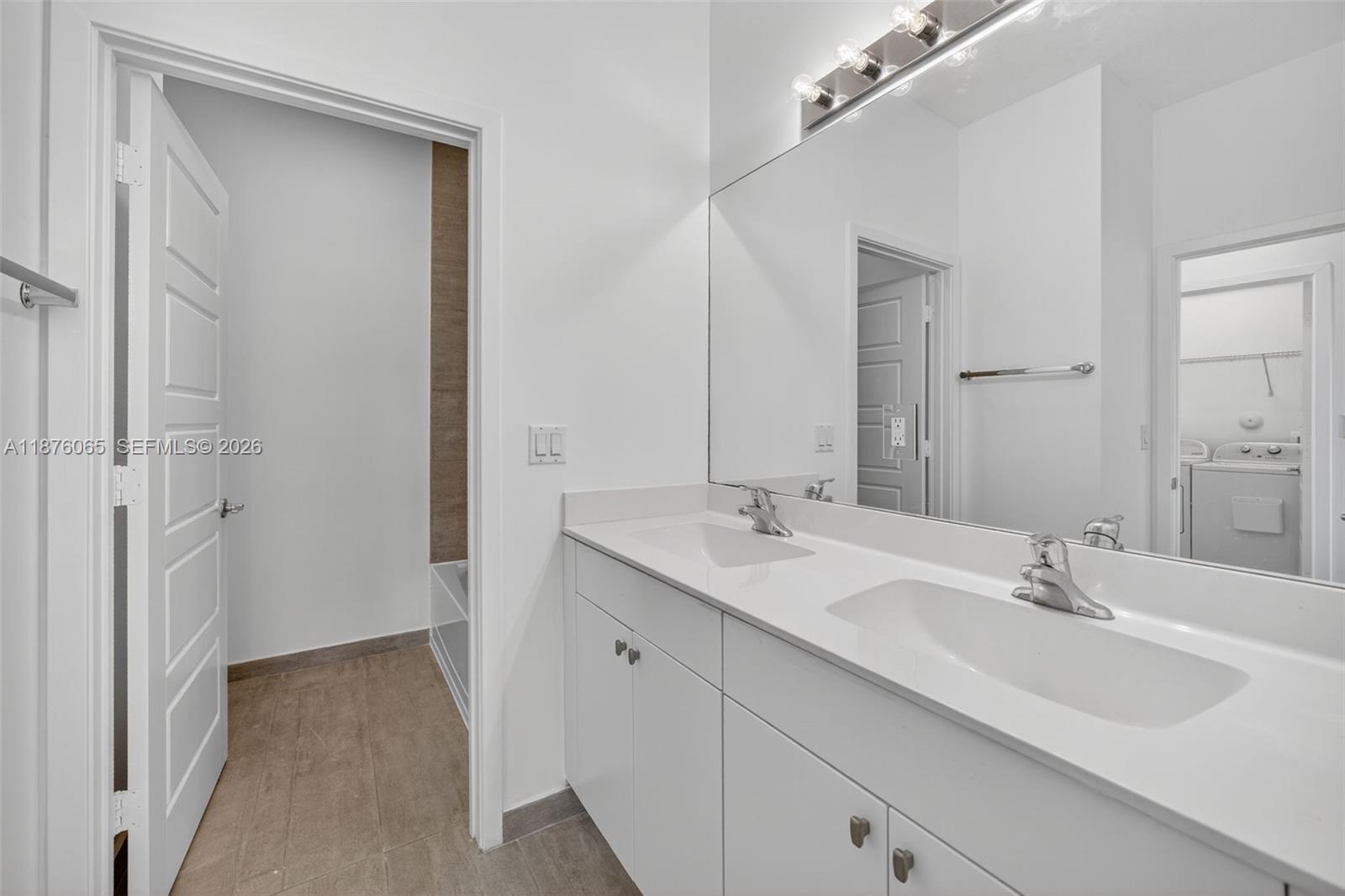 17606 Southwest 149th Place, Unit 17606 Miami, FL 33187 - Photo 40 of 69 a bathroom with a sink and a mirror