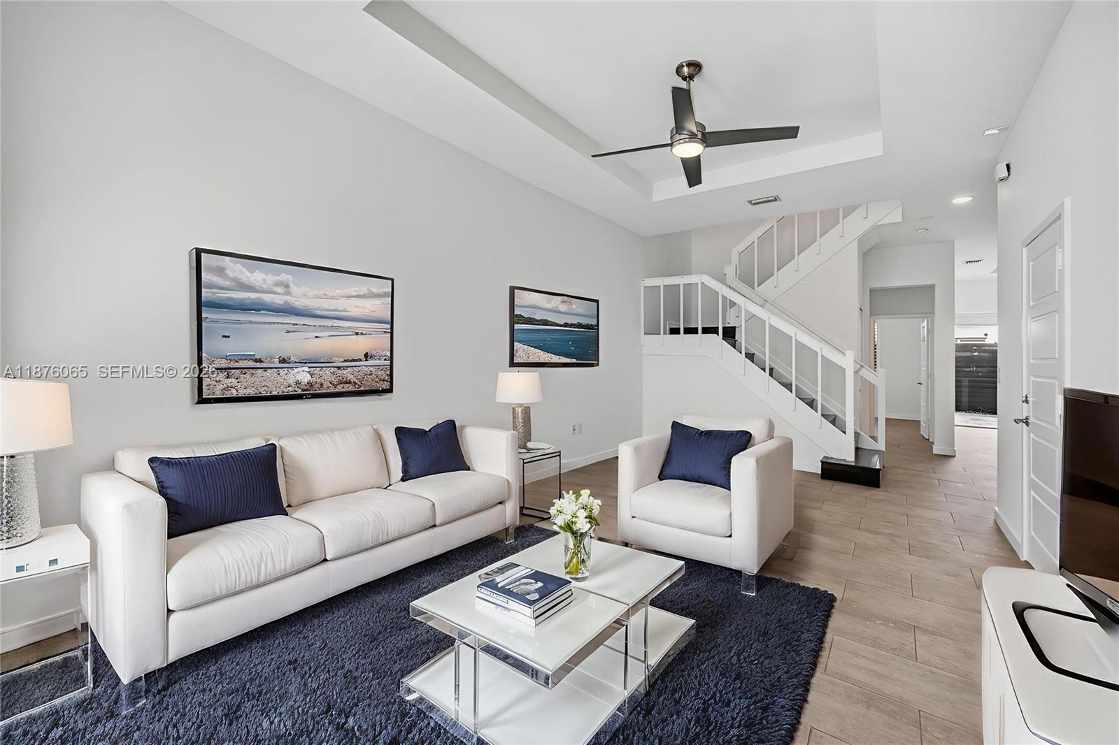 17606 Southwest 149th Place, Unit 17606 Miami, FL 33187 - Photo 4 of 69 a living room with furniture and a ceiling fan