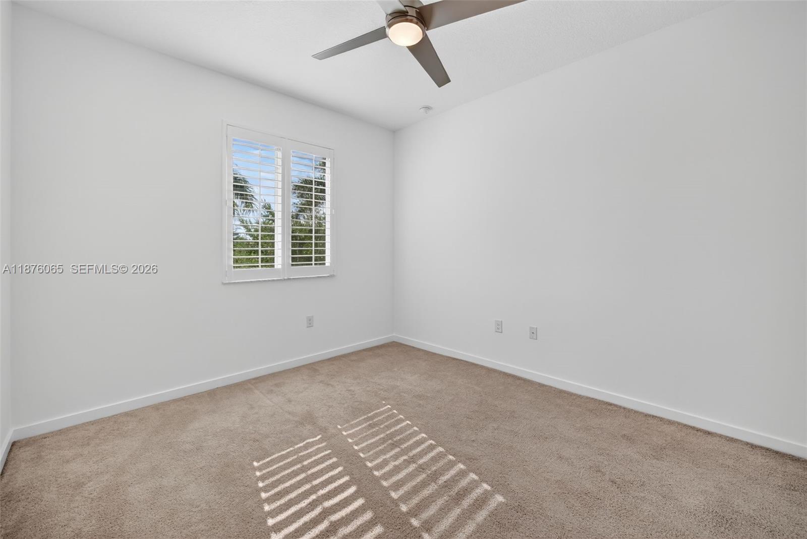 17606 Southwest 149th Place, Unit 17606 Miami, FL 33187 - Photo 43 of 69 an empty room with a window and a fan