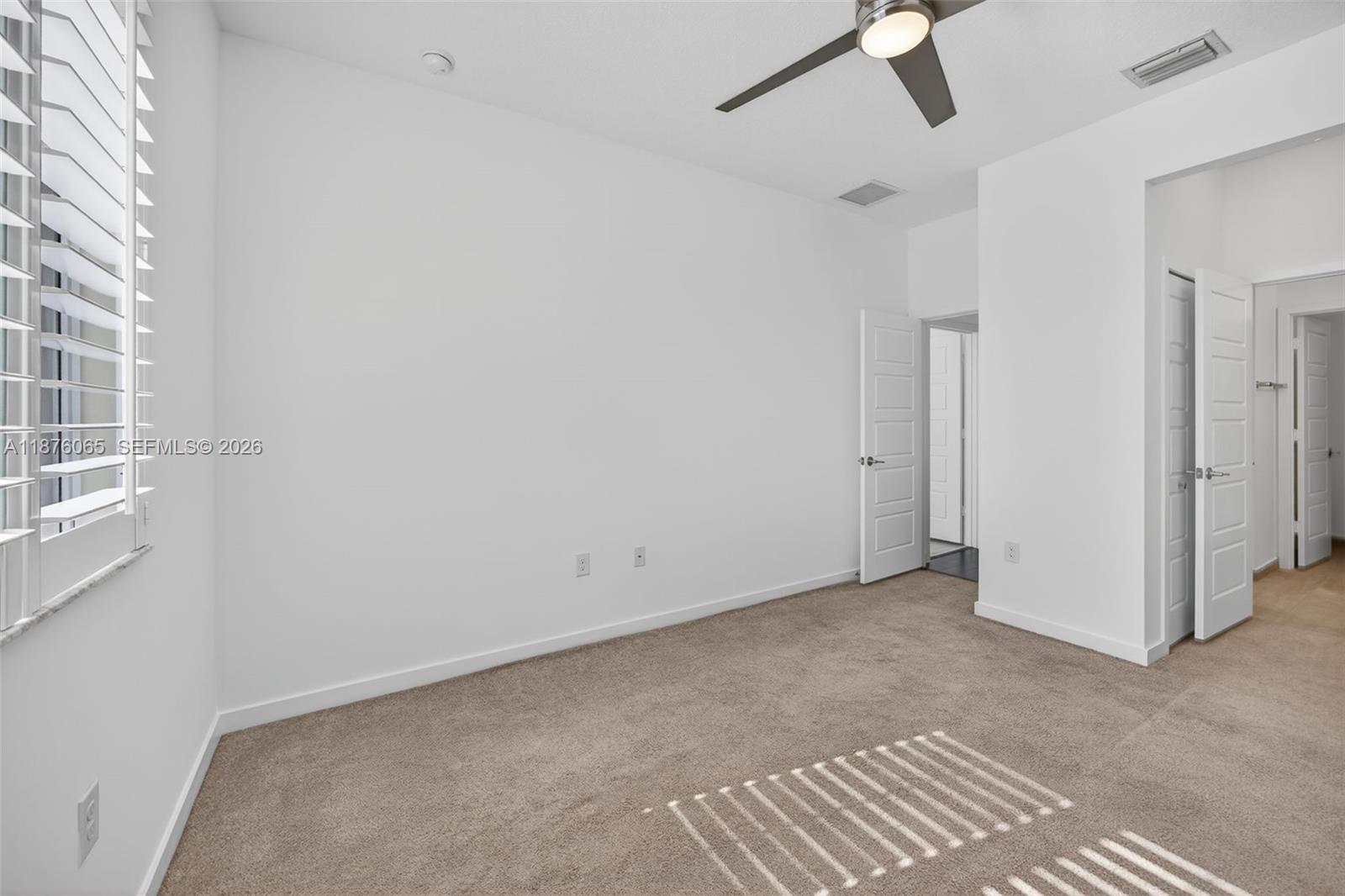 17606 Southwest 149th Place, Unit 17606 Miami, FL 33187 - Photo 44 of 69 a view of an empty room with a window
