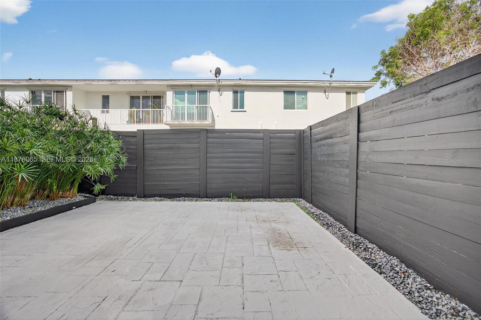 17606 Southwest 149th Place, Unit 17606 Miami, FL 33187 - Photo 54 of 69 a view of a house with a wooden fence