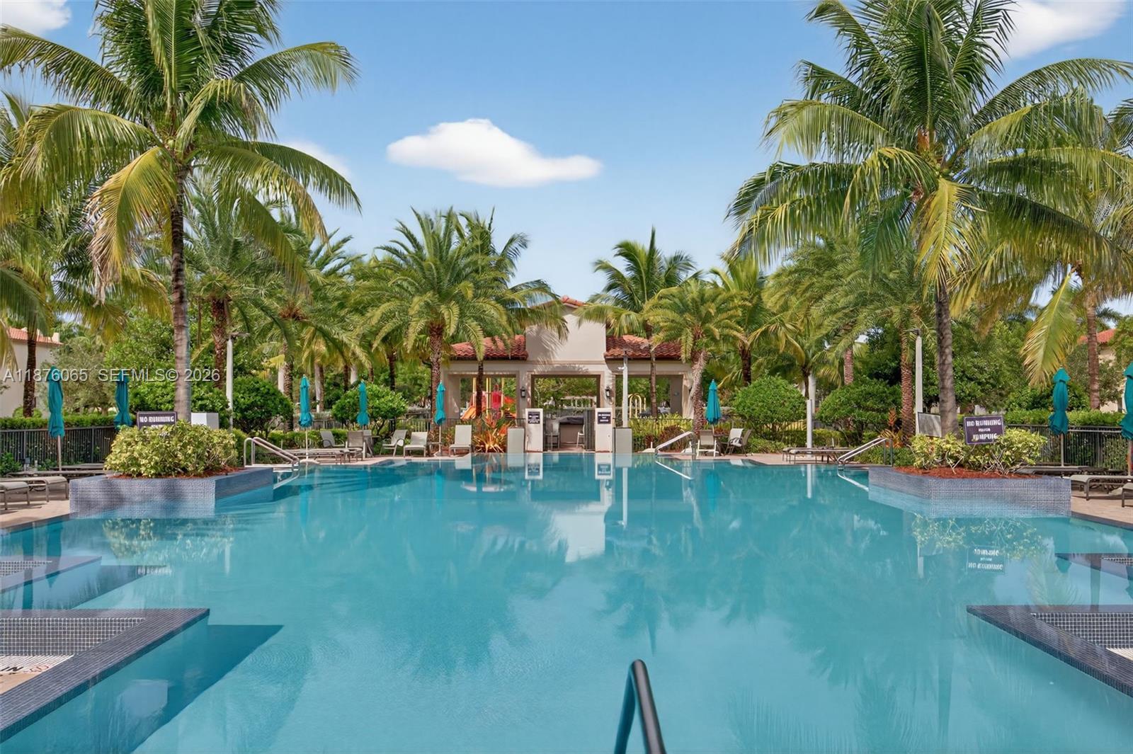 17606 Southwest 149th Place, Unit 17606 Miami, FL 33187 - Photo 67 of 69 a view of a swimming pool with a garden and plants