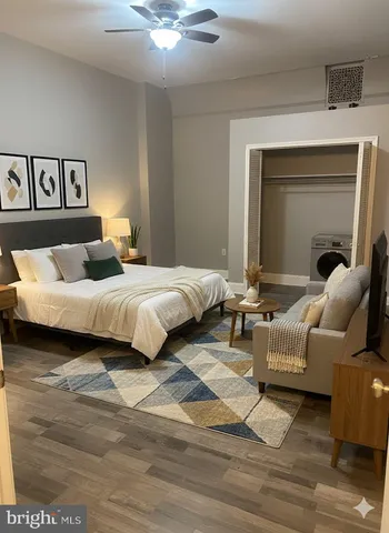 a bedroom with a bed and a couch