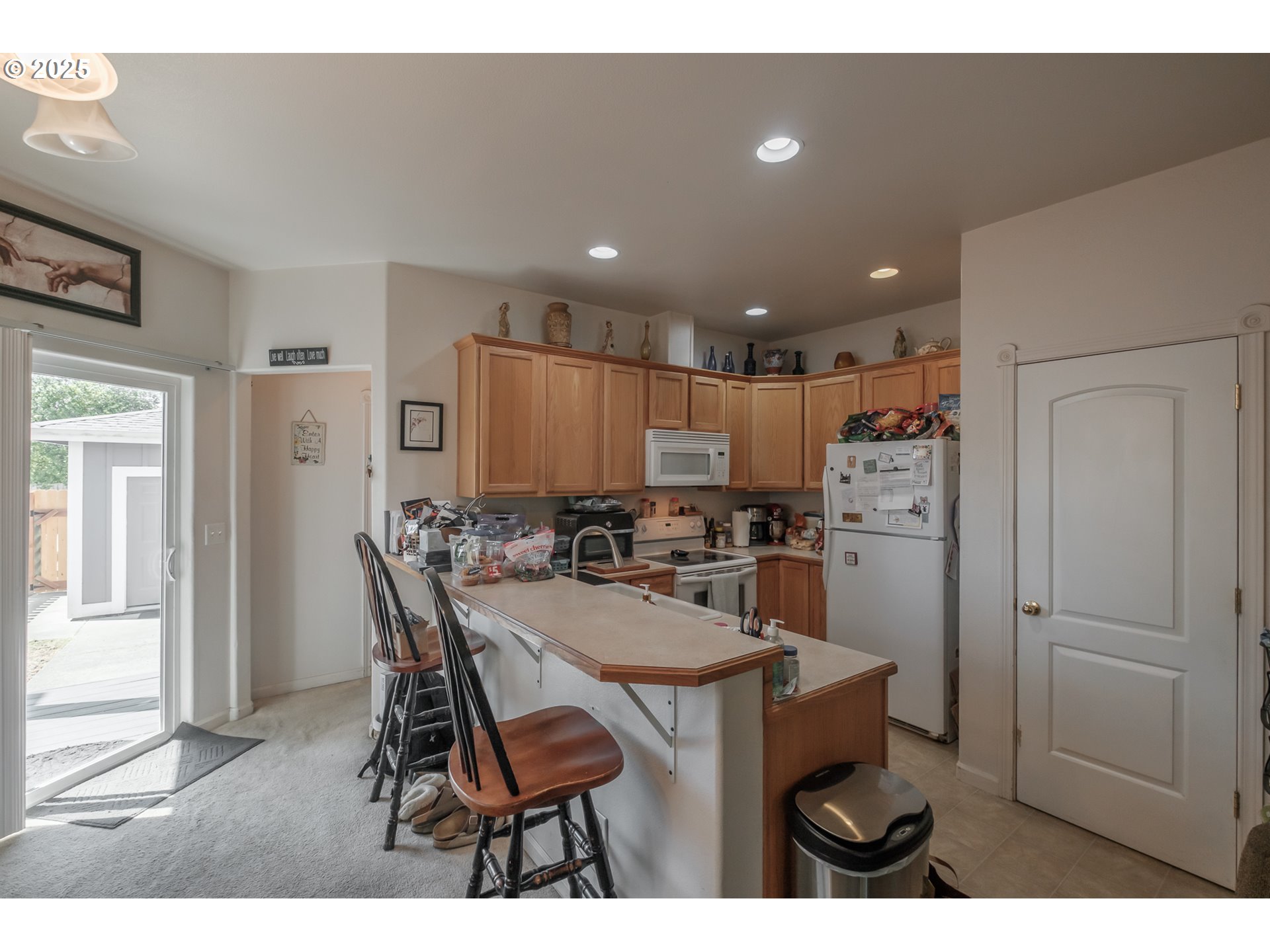 1036 9th Street Florence, OR 97439 - Photo 14 of 47 a kitchen with refrigerator and chairs
