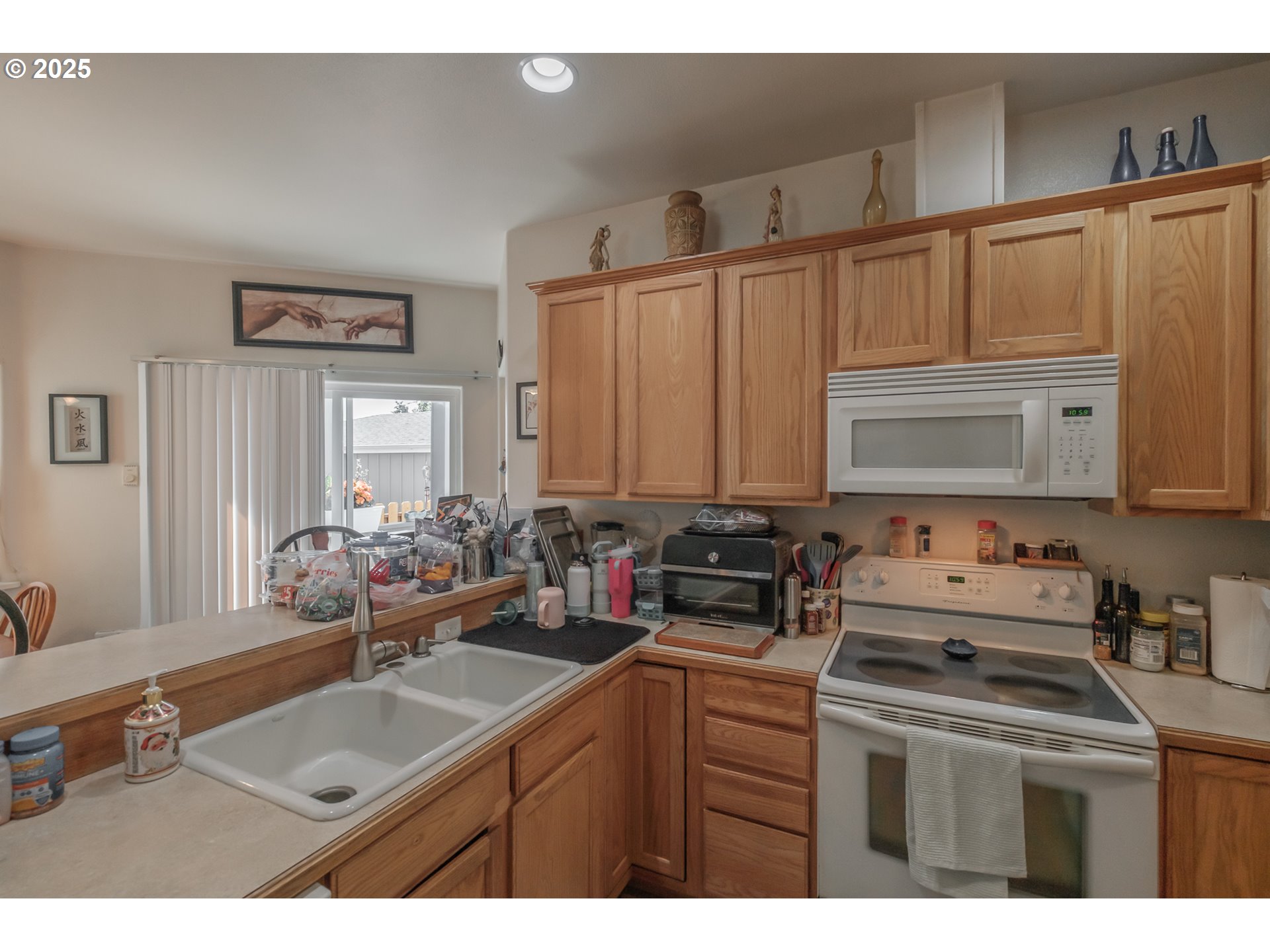 1036 9th Street Florence, OR 97439 - Photo 17 of 47 a kitchen with a sink stove and cabinets