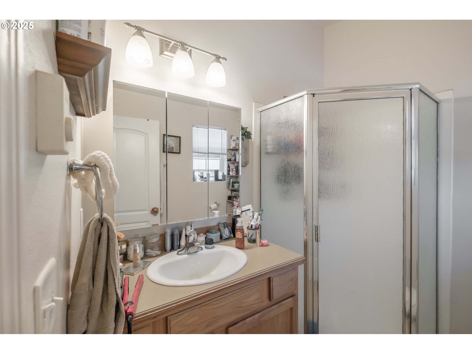 1036 9th Street Florence, OR 97439 - Photo 34 of 47 a bathroom with a sink mirror and shower