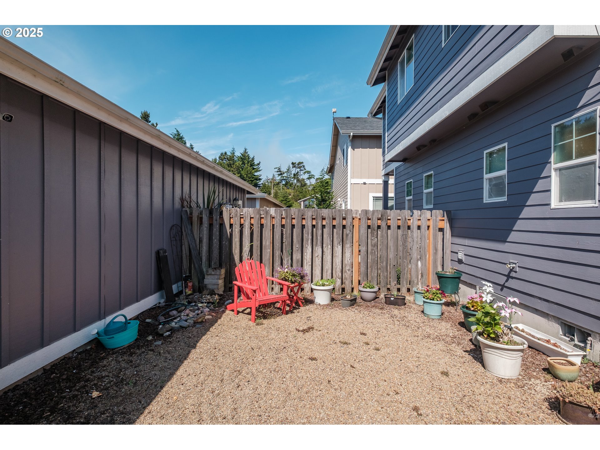 1036 9th Street Florence, OR 97439 - Photo 39 of 47 a view of a backyard with a chair and potted plants
