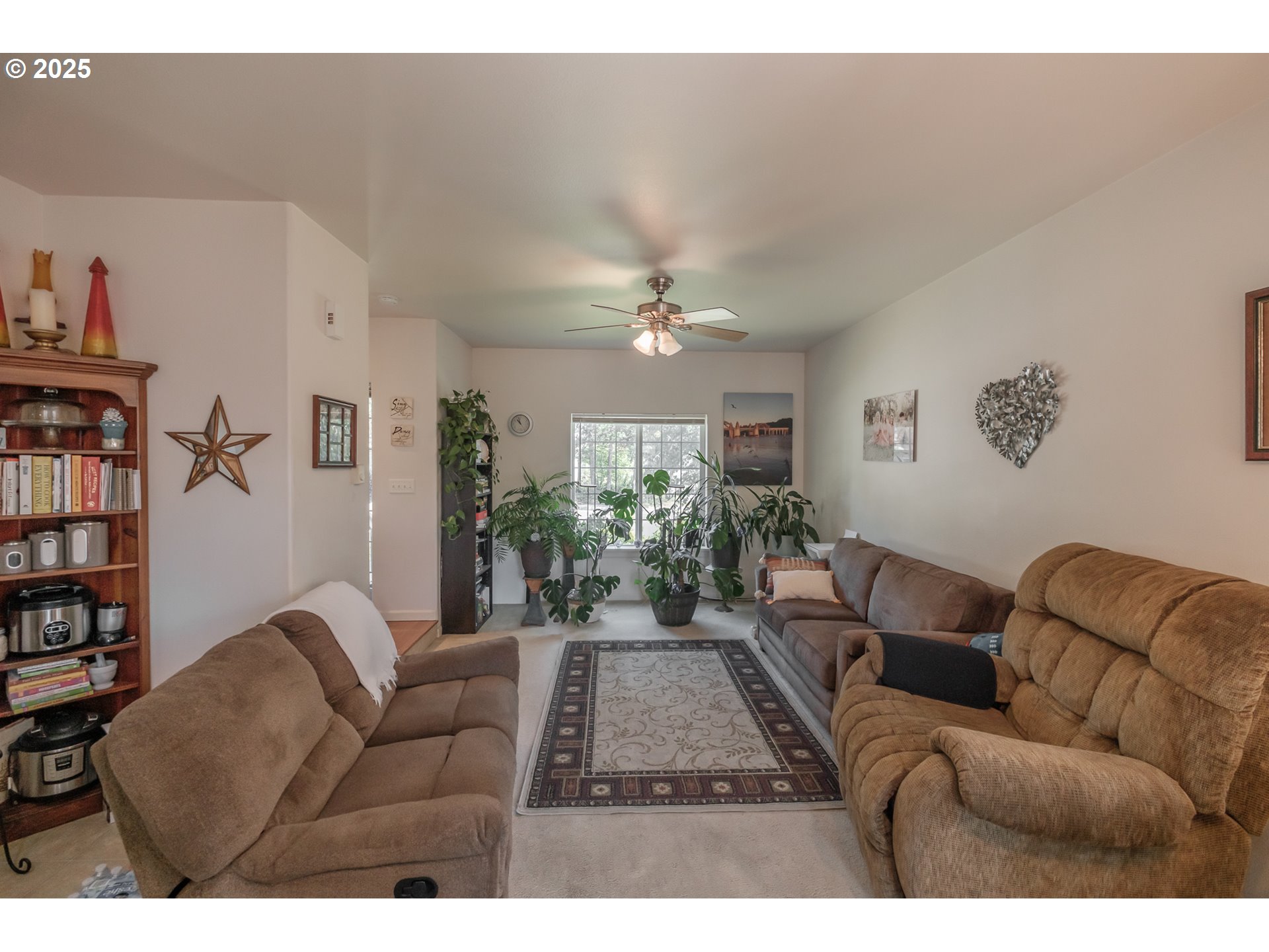 1036 9th Street Florence, OR 97439 - Photo 10 of 47 a living room with furniture and a bookshelf with wooden floor