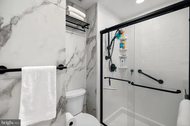 a bathroom with a toilet and a shower