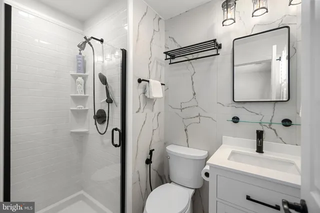 a bathroom with a toilet sink and shower