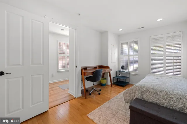 a bedroom with a bed and a table