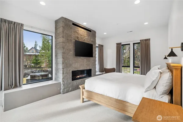 a spacious bedroom with a bed and a flat screen tv