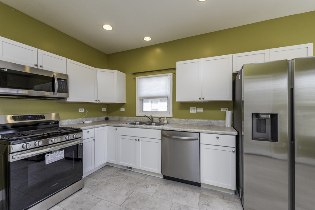 515 2nd Street, Unit 2 Waukegan, IL 60085 - Photo 13 of 27 a kitchen with stainless steel appliances a stove a sink and a microwave