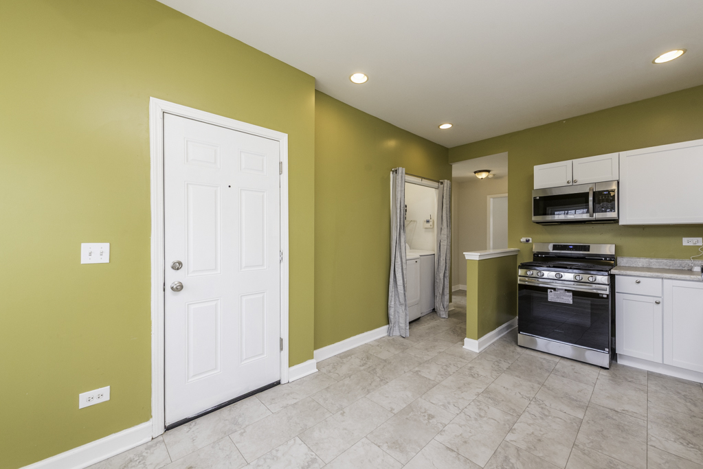 515 2nd Street, Unit 2 Waukegan, IL 60085 - Photo 15 of 27 a open kitchen with stainless steel appliances a refrigerator and a stove top oven