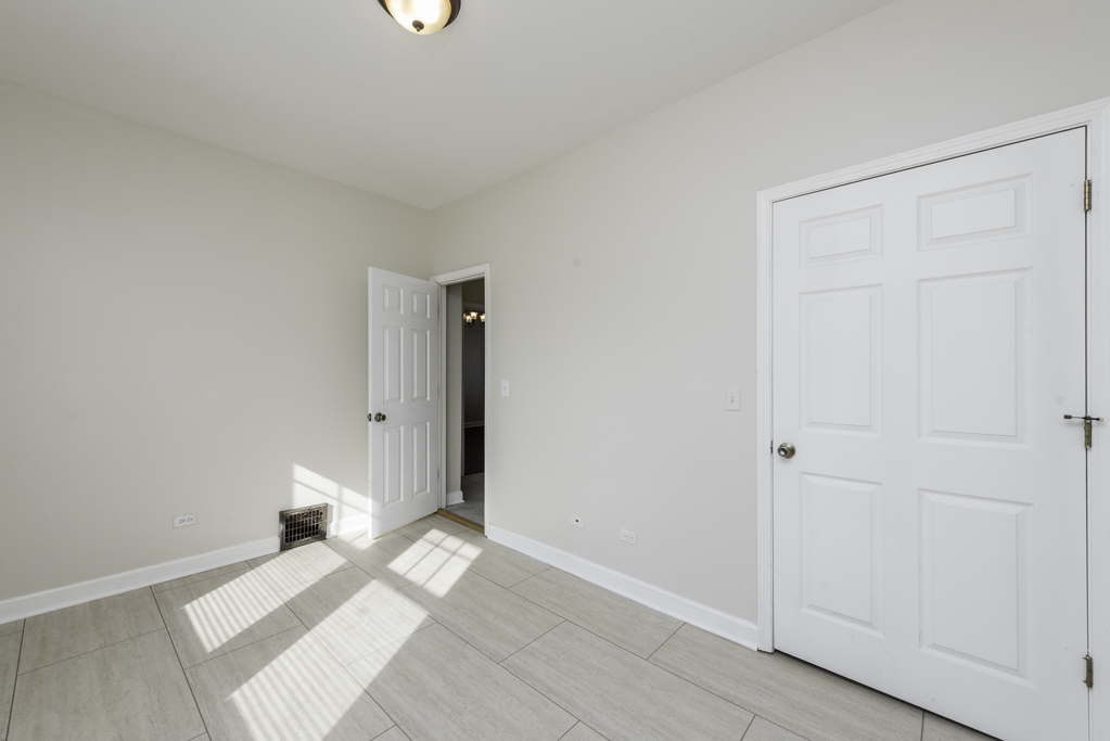 515 2nd Street, Unit 2 Waukegan, IL 60085 - Photo 18 of 27 a view of a bedroom with closet