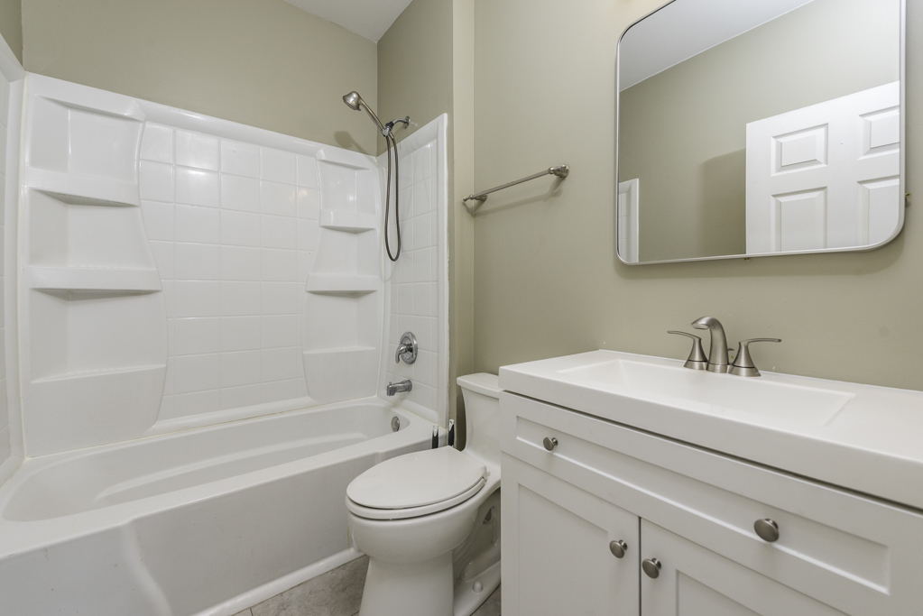 515 2nd Street, Unit 2 Waukegan, IL 60085 - Photo 19 of 27 a bathroom with a sink a toilet and a bathtub