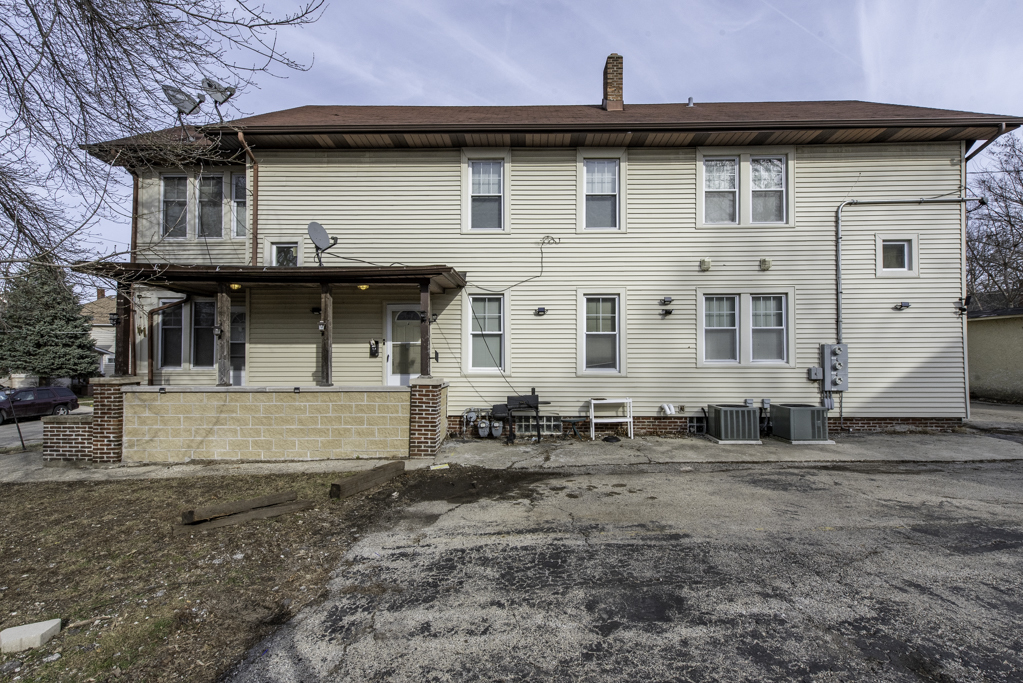 515 2nd Street, Unit 2 Waukegan, IL 60085 - Photo 25 of 27 a view of a white house with large windows and a yard