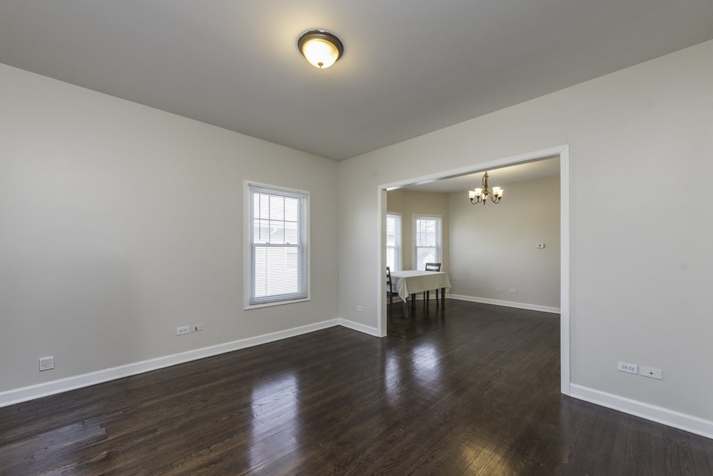 515 2nd Street, Unit 2 Waukegan, IL 60085 - Photo 4 of 27 an empty room with wooden floor and windows