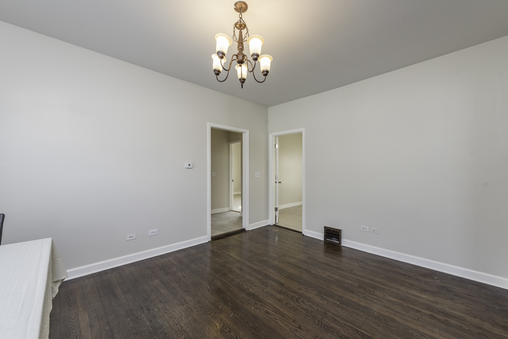 515 2nd Street, Unit 2 Waukegan, IL 60085 - Photo 10 of 27 a view of a hallway with wooden floor and chandelier