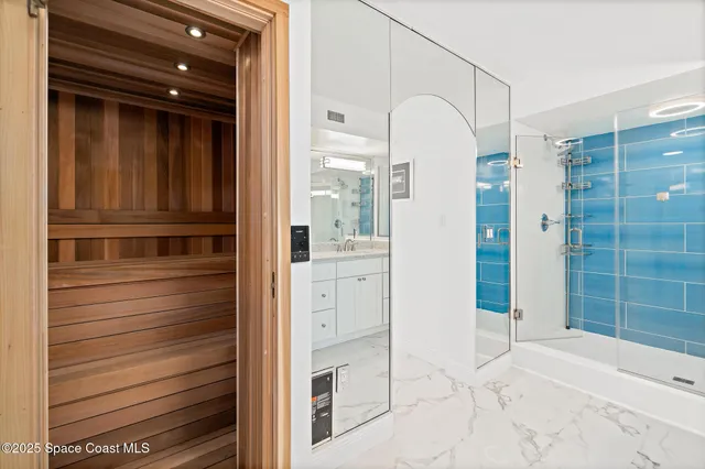 a view of walk in closet and bathroom