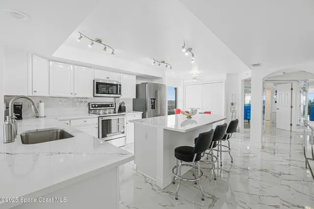 a kitchen with a sink and a large window