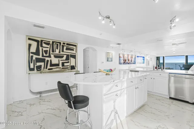 a kitchen with stainless steel appliances kitchen island granite countertop a sink and cabinets