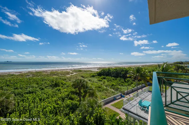a view of a city with tall buildings and a big yard