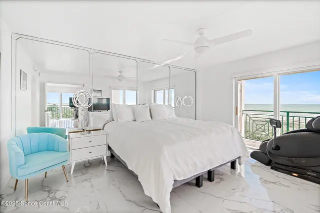 a bed room with a bed and a chair