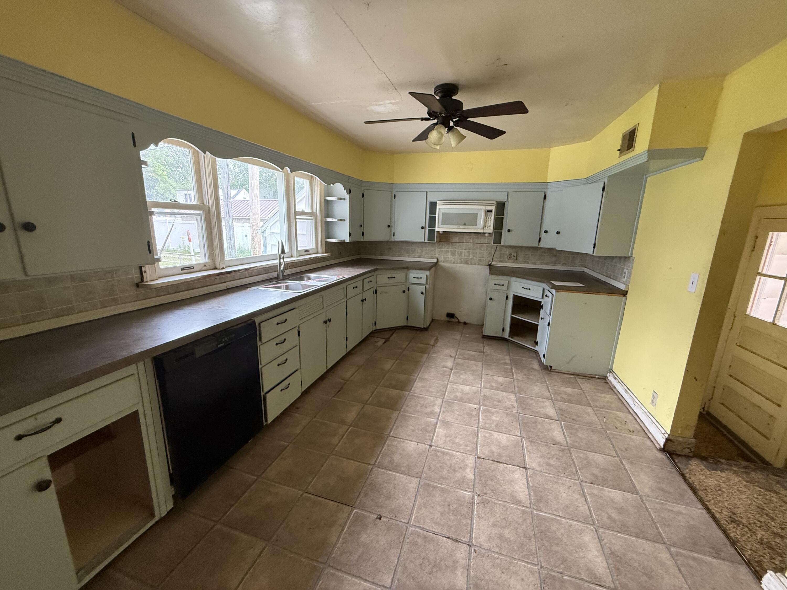 118 West Spring Street Winamac, IN 46996 - Photo 4 of 11 a kitchen with a sink a counter top space appliances and cabinets