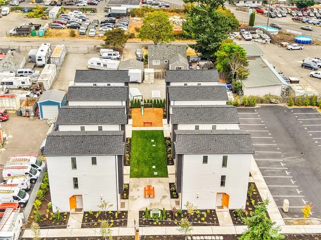 an aerial view of residential houses with outdoor space