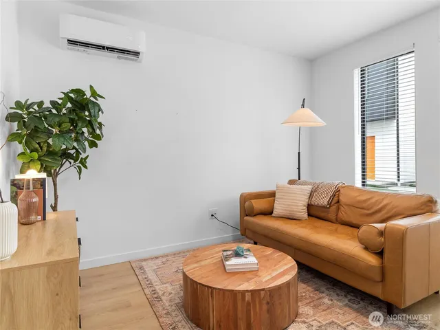 a living room with furniture and a potted plant