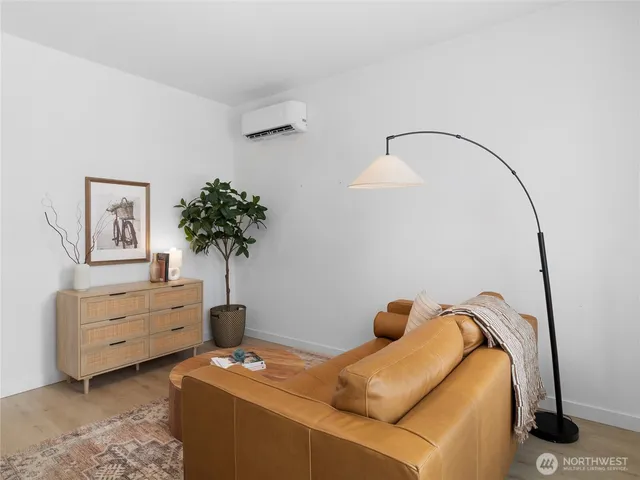 a bedroom with bed and a potted plant